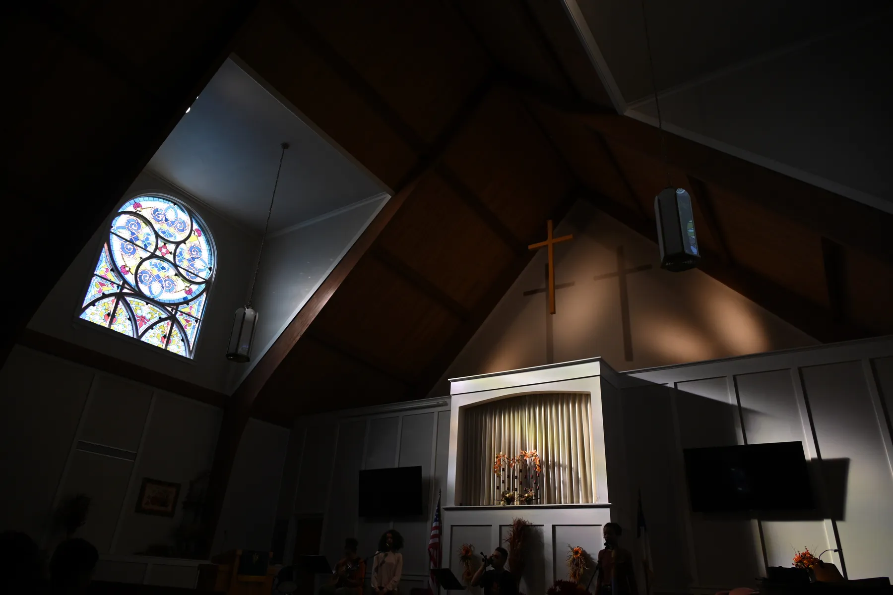 Church sanctuary with stained glass window
