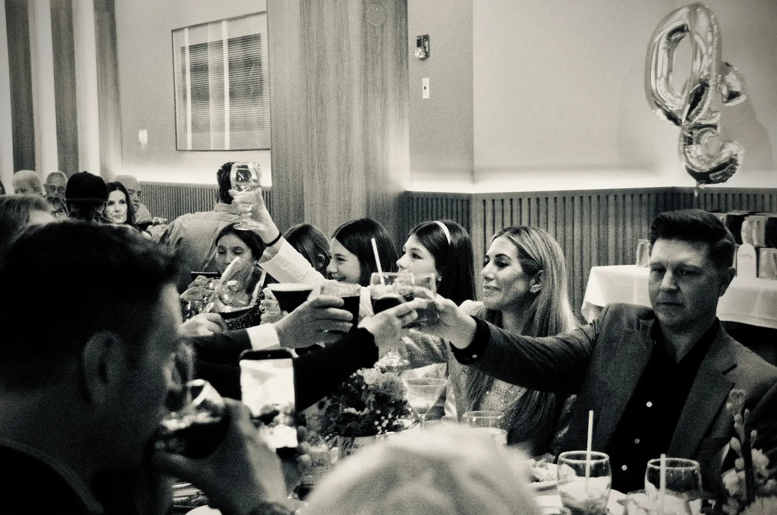 Guests raising their glasses in a toast