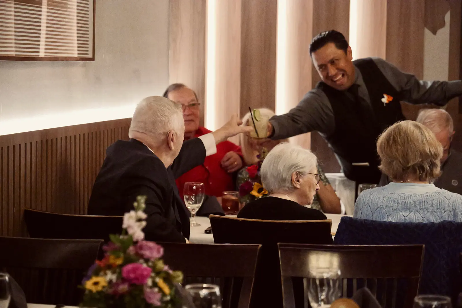 Friends sharing a laugh and a toast at a celebration